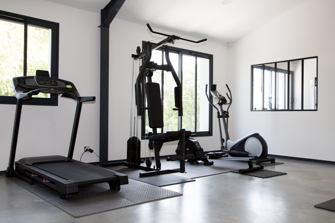 Room with gym equipment sport machines in fitness room